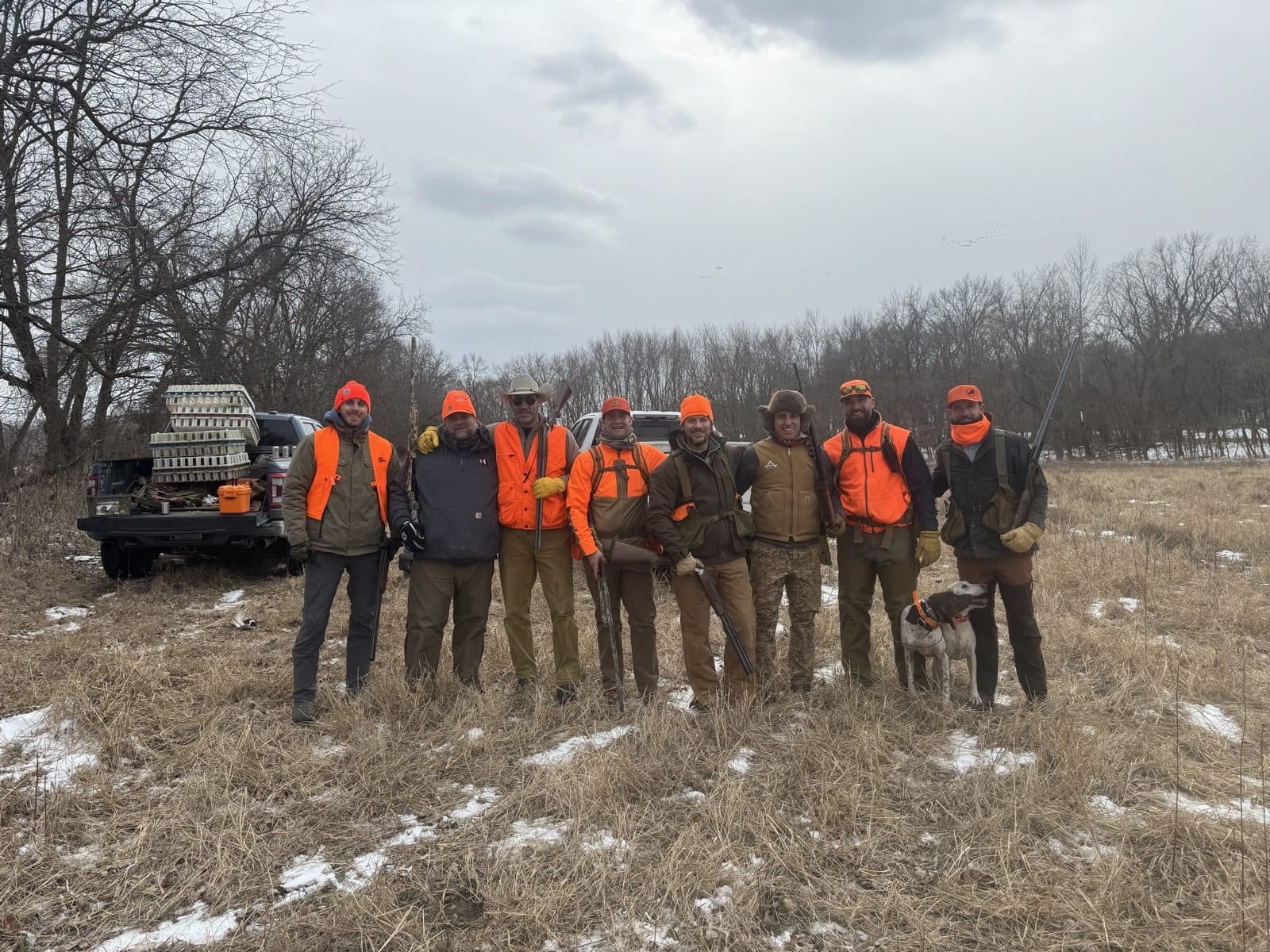Full hunting crew in blaze orange on a snowy day